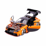  Mazda RX-7 mit Han's Figur Metallic Orange „Fast&Furious“ 1997 1:24